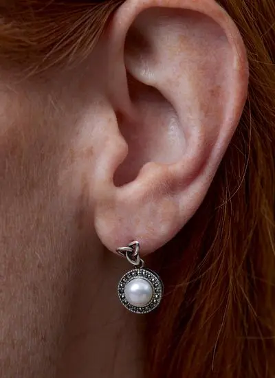 Close up shot of red haired model wearing Sterling Silver Trinity Knot Marcasite 